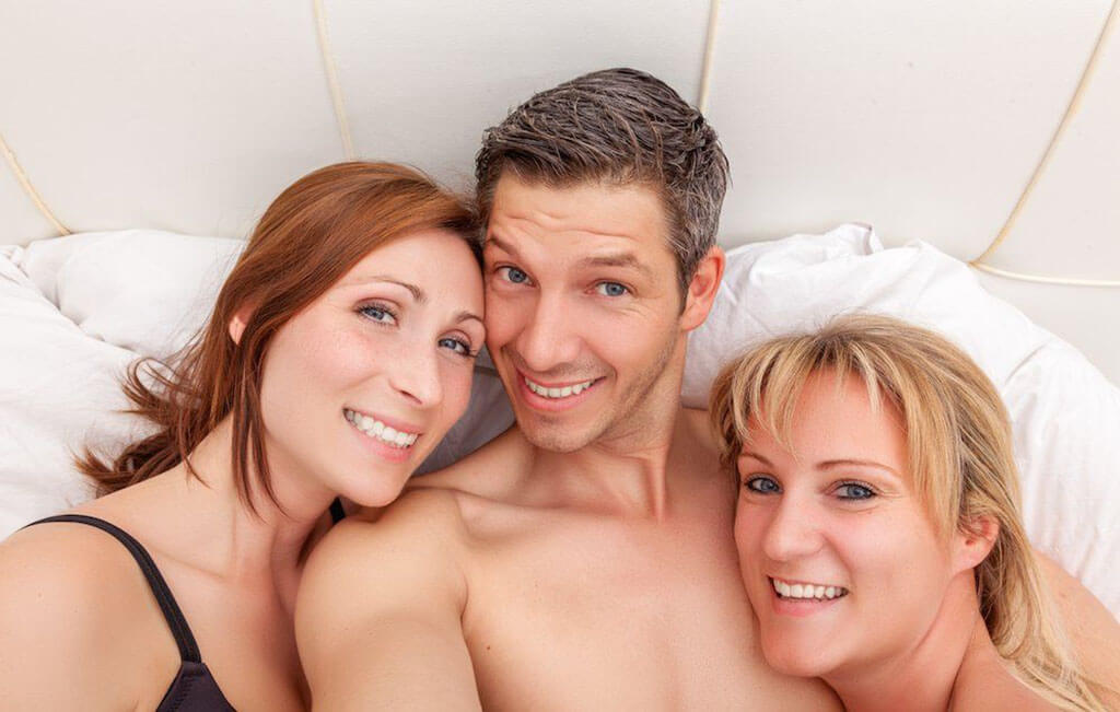 Three Happy People on a Bed