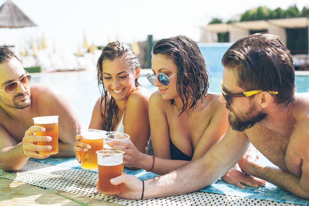 Couples with beer at the pool