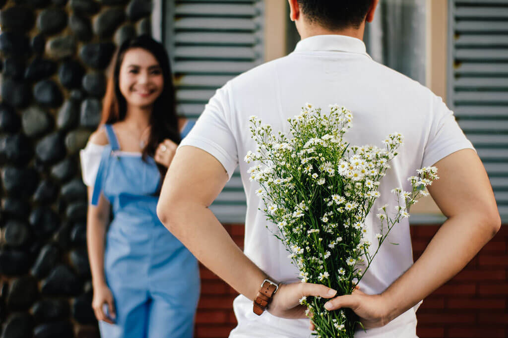 Man Holding Baby's Breath Flower While Dating