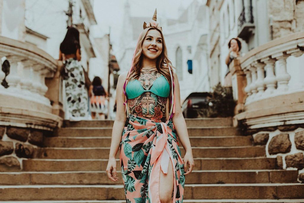 woman in green and white floral dress wearing gold crown